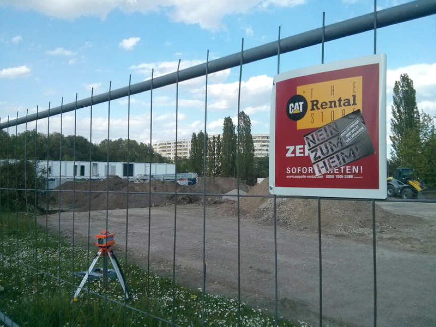 Ein in Hellersdorf aufgenommenes Foto zeigt einen Bauzaun, an welchem Nazis ein Aufkleber angebracht haben mit der Aufschrift: "Nein zum Heim".