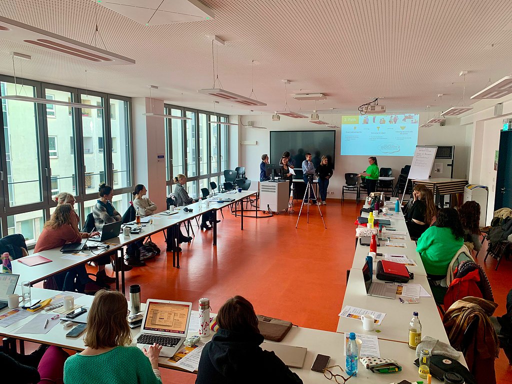 Students together in the seminar room. Presented at the front.