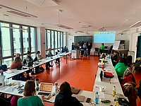 Students together in the seminar room. Presented at the front.