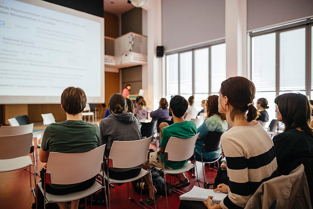 Studierende sitzen im Audimax und hören sich eine Vorlesung an