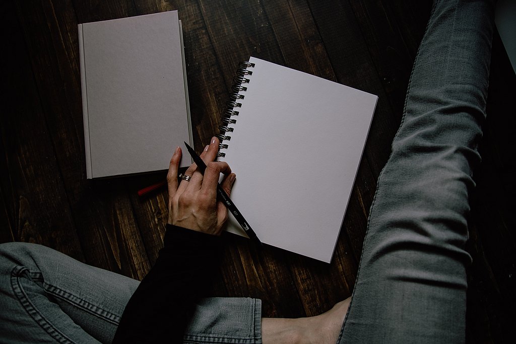 Person mit Stift und Notizblock