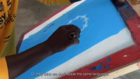 Still from a movie: a hand paints a wreath of thorns on the light blue background of the screen. Below it is the subtitle: "or they think we don't speak the same language"