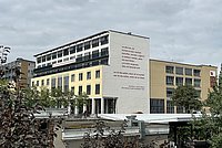 Maxi Obexers Gedicht an der Südfassade der ASH Berlin - davon der Bahnhof und Begrünung