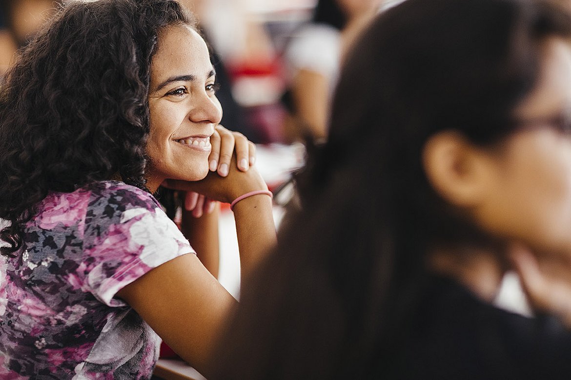 Portrait of a smiling student during a lecture that is part of the Master of Arts Social Work as a Human Rights Profession