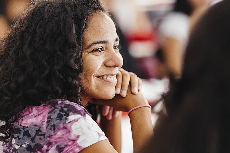 Portrait of a smiling student during a lecture that is part of the Master of Arts Social Work as a Human Rights Profession