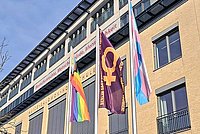 Die Berliner-Anti-Gewalt-Flagge weht zwischen der Progress-Pride und der Trans* Flagge vor dem Hauptgebäude Alice Salomon Hochschule